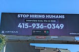 Billboard reading STOP HIRING HUMANS Interview Ava, the AI BDR. Beneath that text is a phone number with San Francisco area code 415. In the corners are the corporate wordmark for ARTISAN and Artisan’s website, artisan.co.
