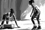 A female basketball player is foam rolling as she chats to her teammate ahead of their team practice