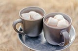 Two cops of hot chocolate with marshmallows