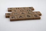 Scrabble blocks that spell out This Too Shall Pass