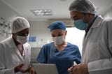 a group of healthworkers using the tablet at the hospital. mediverseai.