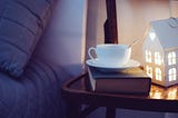 Evening bedside with cup of tea and beautiful home nightlight