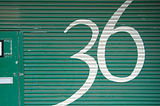 The number 36 is a pretty special kind of number, this graphic on a garage door is a painted number thirty six in white