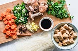 Chopping board full of vegetables and spices