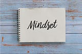 A notebook with the word mindset written on it.
