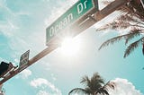 Green Ocean Dr. road sign under the sun