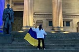 veronika stood on the steps of st george’s hall holding the ukraine flag