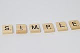 Scrabble tiles spell the word “simple.”