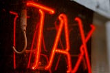 TAX in neon red