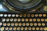 A zoomed-in keyboard of an antique typewriter.