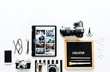 Photography gadgets arranged side by side on white surface.