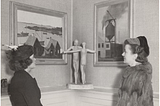 two-women-admire-art-in-a-gallery-setting