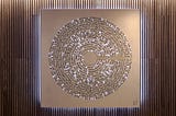 Metal artwork on a wooden wall
