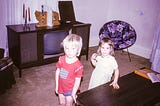 Two children in front of television, 1974