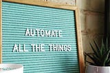 “Automate All the Things” written on a board