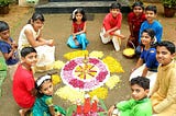 Kids making pookalam, an intricate and colourful arrangement of flowers laid on the floor during Onam days as part of the tradition. Souce: Internet