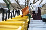 Farmer pouring a bag of Pioneer corn seed into the hopper of a planter.