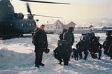 A photo of the author next to a helicopter in Bosnia.