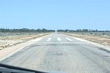 A road through the Australian outback with an emergency airstrip marked on it