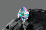 A diamond with all colorful color reflection stuck between two stones