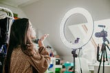Young woman recording video for social media