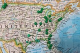 A map of the United States with push pins in different locations showing a planned trip