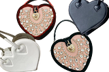 Various styles of heart shaped handbags. White heart shaped, red heart shaped, leather and velviet embellished