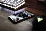 Smartphone on a table next to a computer keyboard