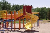 A brightly coloured children’s playground during the day