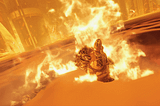 Terminator 2 death meme image from DOOM video game in which a robotic hand is giving a thumbs up from a molten lake of fire.