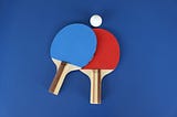 Red and blue ping pong paddles