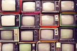 Photo of a stack of vintage TV sets.