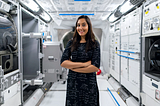 Women in Science, a photo of a smiling women aeronautical engineer working and posing with arms crossed