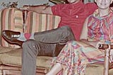 My grandfather and grandmother sitting in lawn chairs put out for a party in the D. Tuazon house. Circa 1960s.