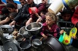 Hungry Palestinians including children hold empty bowls for scraps of food in Gaza this week.