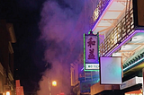 Smoke on a China Town street coming from a large collection of firecrackers.