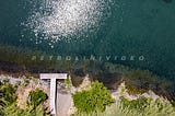 Licenza: Commerciale / Titolo: Aerial view of a small lakeside pier surrounded by a thick veger / Descrizione: Aerial view of a small pier, or pier, on the edge of Lake Bracciano surrounded by thick vegetation. Trevignano. / Keywords: adventure, aerial, beauty, bivouac, blue, chain, climb, cloud, cold, edge, forest, fresh air, green, hike, hiker, image, lake, landscape, leisure, nature, outdoors, panorama, park, path, photo, ray, relax, ridge, river, rock, scenic, sea, setting, site, sky, sport,