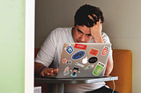 Stressed man working on laptop