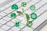 a tiny plant pops out from a computer keyboard with icons of sustainability depicted around it