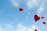 Heart shaped balloons floating into the sky