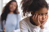 Black mother and daughter, where the daughter is upset