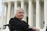 Photo of Aimee Stephens wearing a black jacket in front of US Supreme Court.