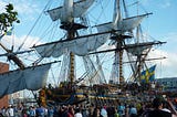 Huge sailing ship with the crowd of people surrounding its base