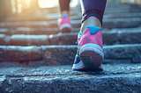 Close-up of a person’s pink sneakers ascending stone steps. AI image created by author in Midjourney