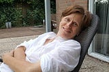 Cecile Janssens relaxes outside with a glass of white wine at her home in Stille Wille, The Netherlands.