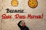 The author in front of the sentence — written on a wall — “Because… Size Does Matter!”