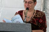 Picture of me reading Thief Eyes at a podium