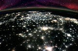 A view of China from space at night. The Earth is all black, except for the bring lights of cities.