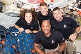 Astronauts Christina Koch, Jeremy Hansen, Reid Wiseman and Victor Glover pose for a photo together inside their Orion spaceship.