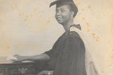 A graduation picture of a young smiling black woman.